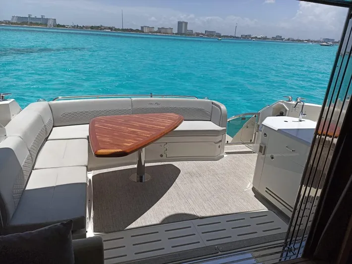 2018 Sea Ray L590 @ Cancun Yacht Photos Pics Luxurious 2018 Sea Ray L590 yacht with elegant seating, wooden table, and stunning ocean view.