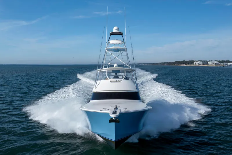 Reel Developers Yacht Photos Pics 2009 Viking 60 Convertible yacht cruising on open water, creating a dynamic wake.