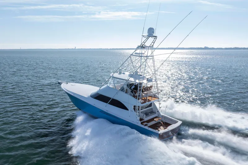 Reel Developers Yacht Photos Pics 2009 Viking 60 Convertible yacht cruising on open water, showcasing sleek design and performance.