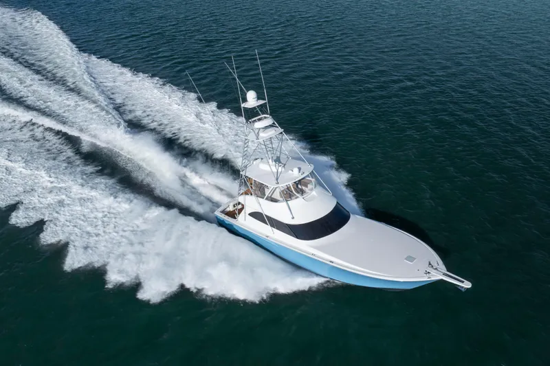 Reel Developers Yacht Photos Pics 2009 Viking 60 Convertible yacht cruising swiftly on open water.