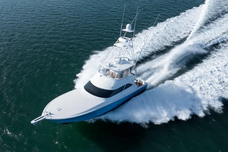 Reel Developers Yacht Photos Pics 2009 Viking 60 Convertible yacht cruising swiftly on open water.