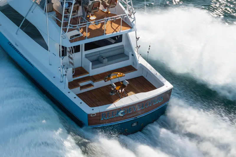 Reel Developers Yacht Photos Pics 2009 Viking 60 Convertible yacht cruising swiftly on open water.