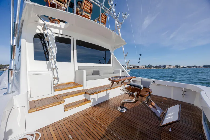 Reel Developers Yacht Photos Pics 2009 Viking 60 Convertible yacht with teak deck and fishing chair on open sea.