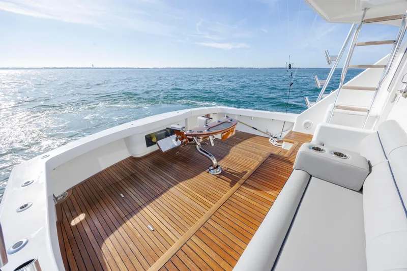 Reel Developers Yacht Photos Pics 2009 Viking 60 Convertible yacht deck with wooden flooring, ocean view, and fishing equipment.