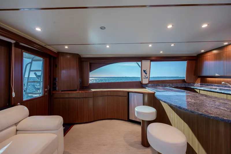 Reel Developers Yacht Photos Pics Luxurious interior of 2009 Viking 60 Convertible yacht with ocean view and elegant wood finishes.