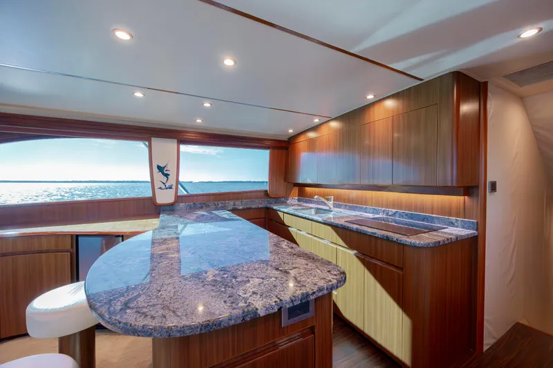 Reel Developers Yacht Photos Pics Luxurious kitchen interior of 2009 Viking 60 Convertible yacht with ocean view.