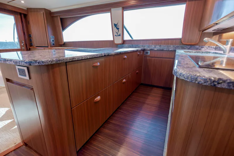 Reel Developers Yacht Photos Pics Luxurious wooden interior of 2009 Viking 60 Convertible yacht kitchen with granite countertops.