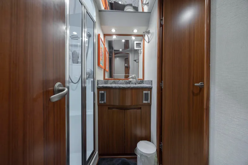 Reel Developers Yacht Photos Pics 2009 Viking 60 Convertible yacht bathroom with wood cabinetry and modern fixtures.