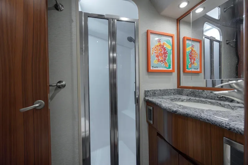 Reel Developers Yacht Photos Pics Luxurious bathroom in 2009 Viking 60 Convertible yacht with granite countertop and modern shower.