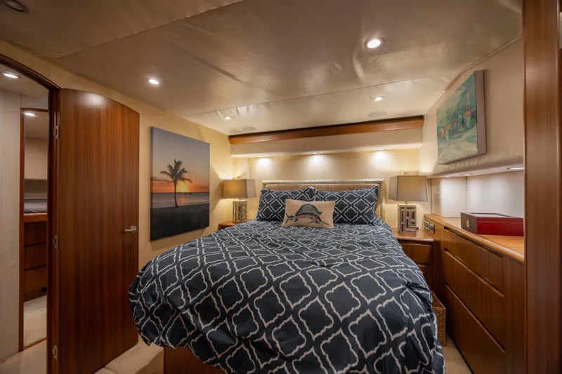 Reel Developers Yacht Photos Pics Luxurious bedroom interior of 2009 Viking 60 Convertible yacht with elegant decor and lighting.