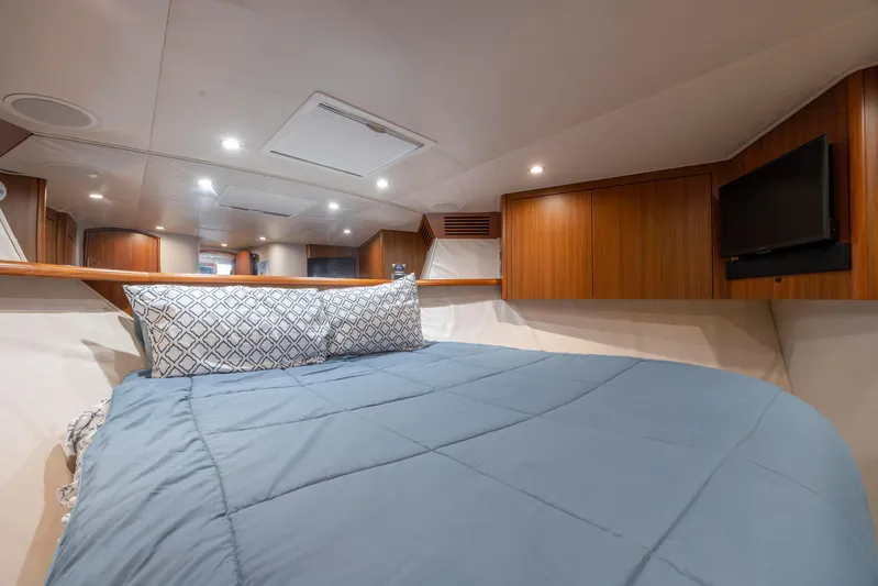 Reel Developers Yacht Photos Pics Luxurious cabin interior of 2009 Viking 60 Convertible yacht with cozy bedding and wood accents.