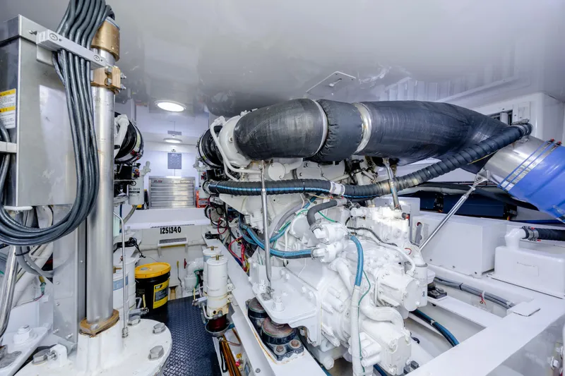 Reel Developers Yacht Photos Pics Engine room of 2009 Viking 60 Convertible yacht, showcasing complex machinery and components.