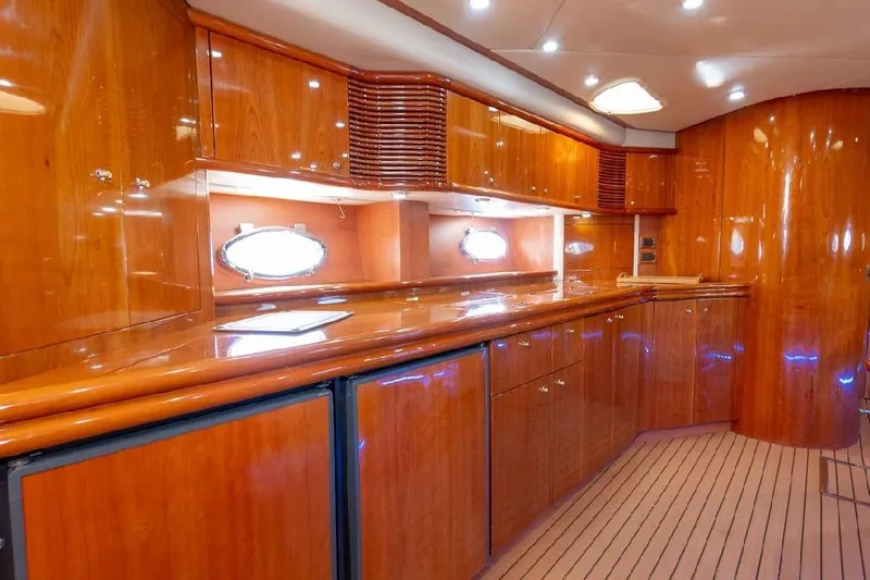  Yacht Photos Pics Luxurious wooden interior of a 2000 Sunseeker Predator 60 yacht, featuring sleek cabinetry and ambient lighting.