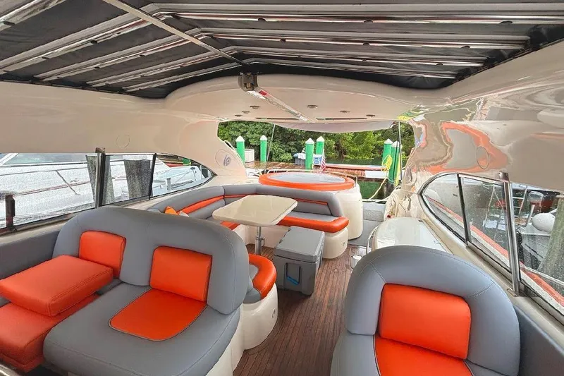 Yacht Photos Pics Luxurious interior of 2000 Sunseeker Predator 60 yacht with orange and gray seating.