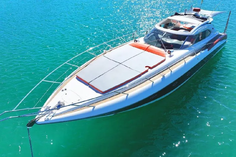  Yacht Photos Pics Sunseeker Predator 60 yacht, 2000 model, cruising on clear turquoise waters.