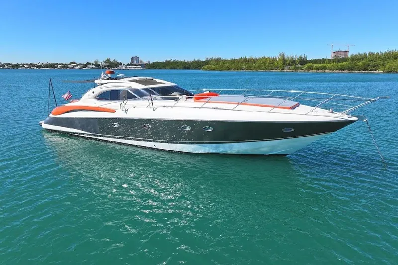  Yacht Photos Pics Sunseeker Predator 60 yacht, 2000 model, anchored in clear blue water.