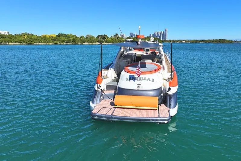  Yacht Photos Pics Sunseeker Predator 60 yacht, 2000 model, anchored in clear blue water.