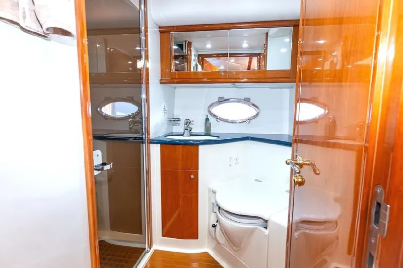  Yacht Photos Pics Luxurious bathroom interior of 2000 Sunseeker Predator 60 yacht with wood accents.