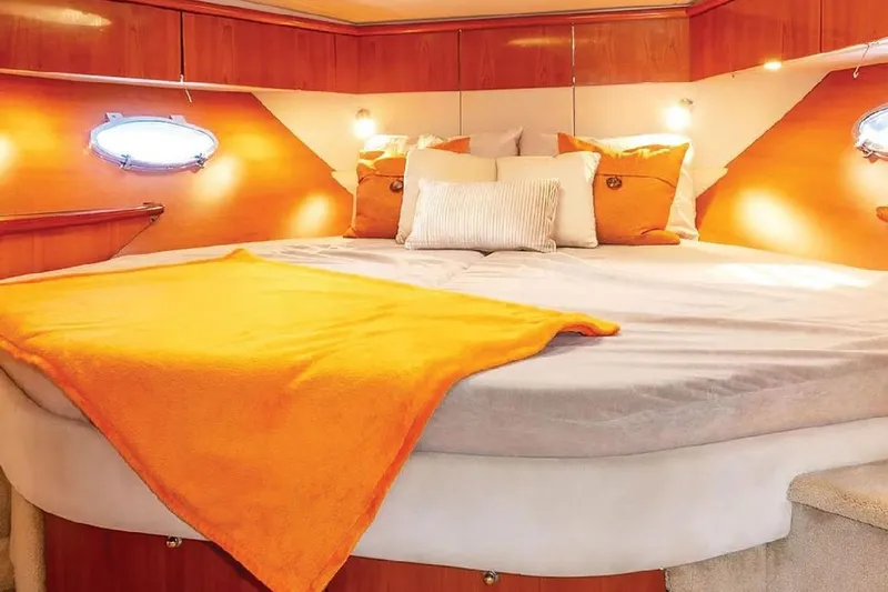  Yacht Photos Pics Luxurious cabin interior of 2000 Sunseeker Predator 60 yacht with cozy bedding.