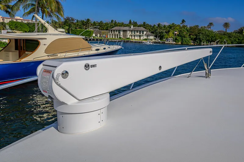 Don't Stop Believing Yacht Photos Pics 2007 Viking 68 Convertible yacht deck with davit, docked near luxury boats and waterfront homes.