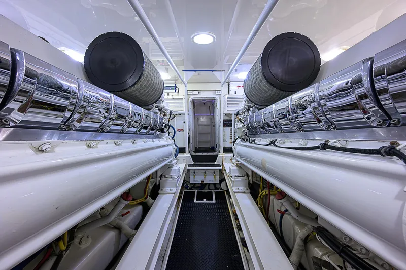 Don't Stop Believing Yacht Photos Pics Engine room of a 2007 Viking 68 Convertible yacht, showcasing sleek, polished machinery.