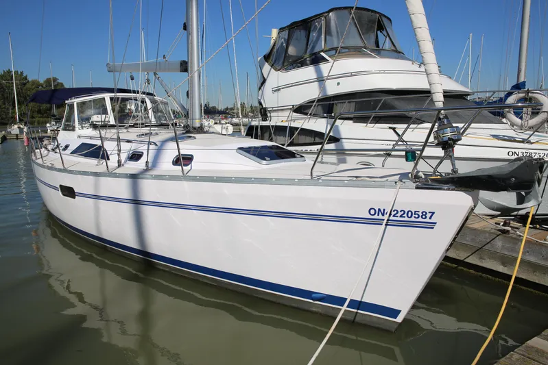 Platypus Yacht Photos Pics 2014 Catalina 445 sailboat docked in marina, featuring sleek white hull and blue accents.