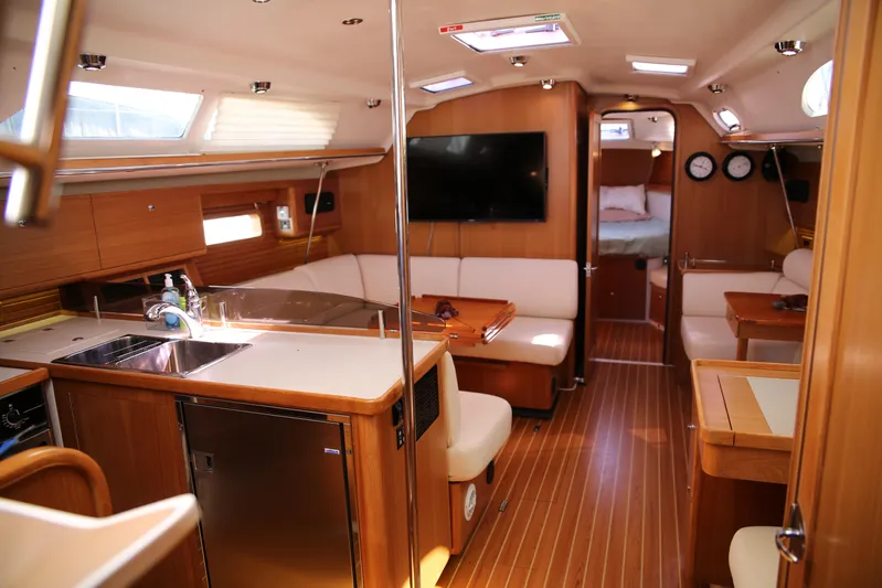 Platypus Yacht Photos Pics Luxurious interior of a 2014 Catalina 445 yacht with modern kitchen and cozy seating area.