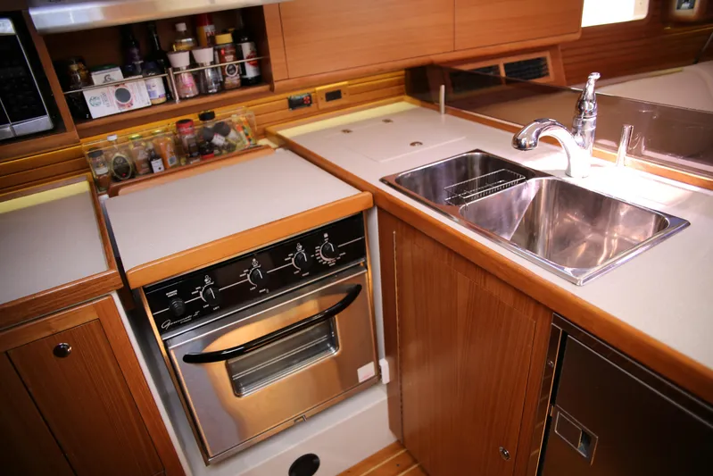 Platypus Yacht Photos Pics Modern kitchen in 2014 Catalina 445 yacht with stove, sink, and wooden cabinetry.