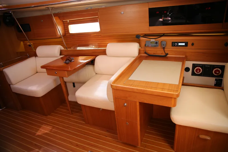 Platypus Yacht Photos Pics Interior of 2014 Catalina 445 sailboat with wooden furnishings and white seating.