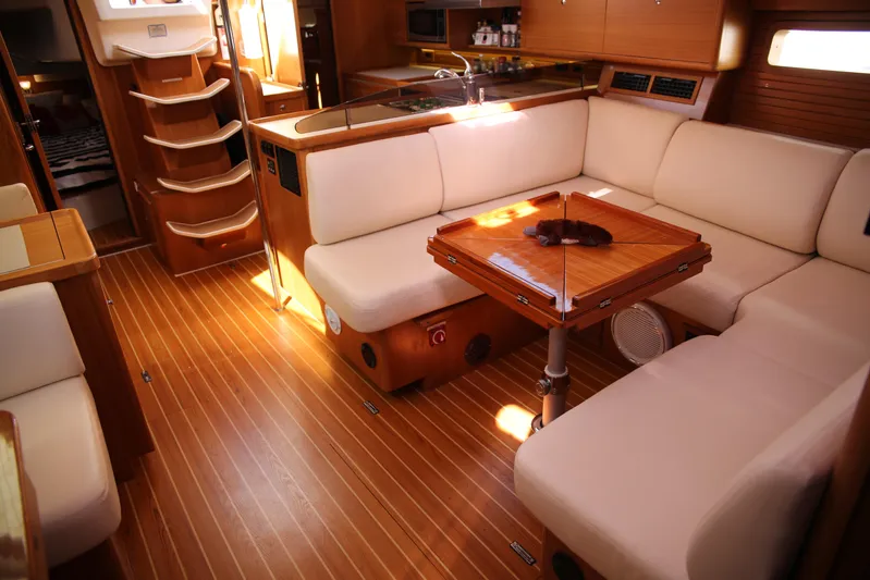 Platypus Yacht Photos Pics Luxurious interior of a 2014 Catalina 445 yacht with wooden flooring and plush seating.