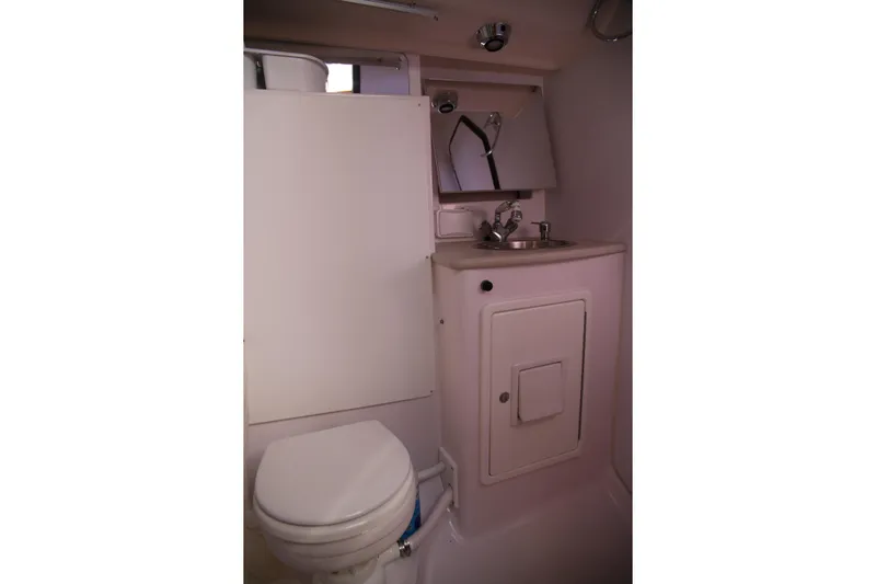 Platypus Yacht Photos Pics Compact bathroom in 2014 Catalina 445 sailboat with toilet, sink, and mirror.