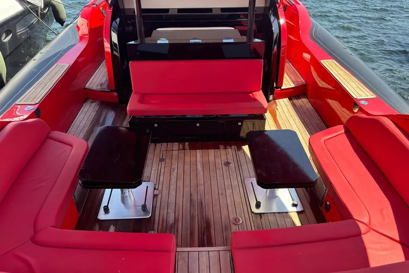  Yacht Photos Pics 2015 SACS Strider 19 boat interior with red seating and wooden flooring.