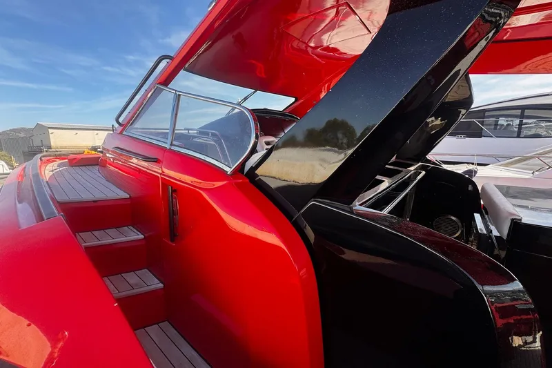  Yacht Photos Pics Red 2015 SACS Strider 19 boat with sleek design and wooden steps.