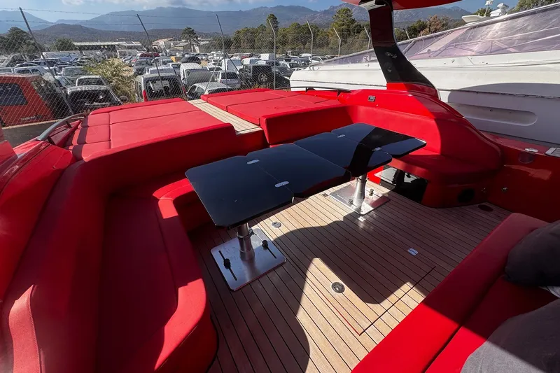  Yacht Photos Pics 2015 SACS Strider 19 yacht interior with red seating and sleek black tables.