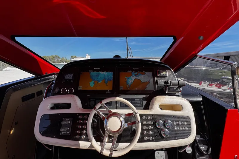  Yacht Photos Pics Cockpit of 2015 SACS Strider 19 with navigation screens and steering wheel.