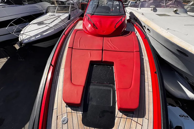 Yacht Photos Pics 2015 SACS Strider 19 yacht with red deck cushions, docked among other boats.