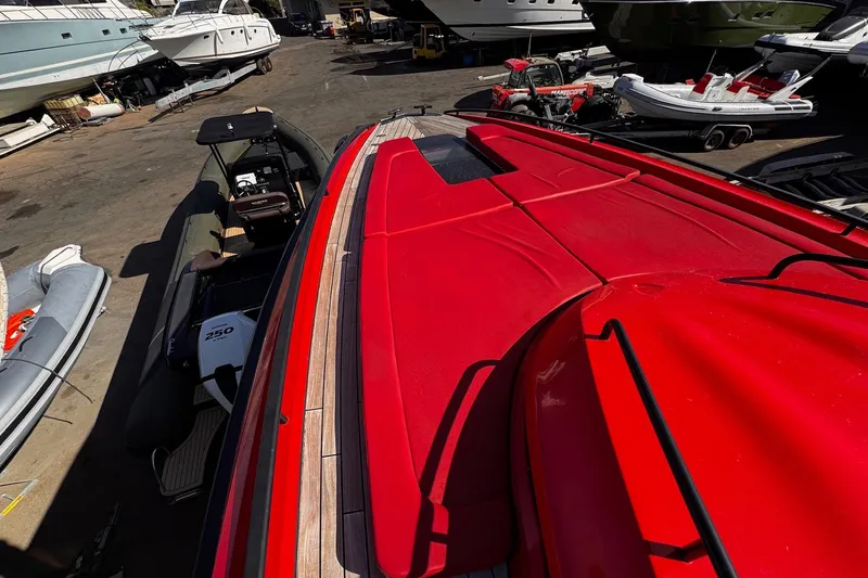  Yacht Photos Pics Red 2015 SACS Strider 19 yacht on dock, surrounded by other boats.