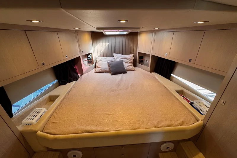  Yacht Photos Pics Luxurious cabin interior of 2015 SACS Strider 19 with cozy bedding and ample storage.