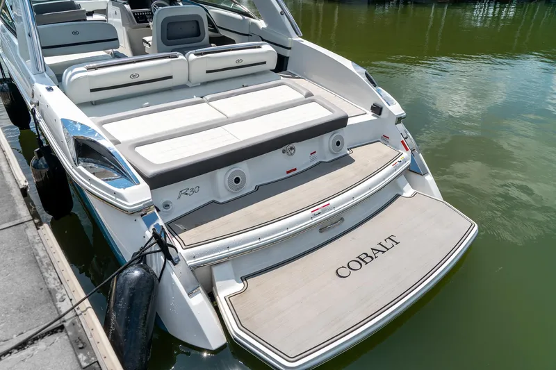  Yacht Photos Pics 2023 Cobalt R30 boat docked, featuring spacious seating and elegant design.