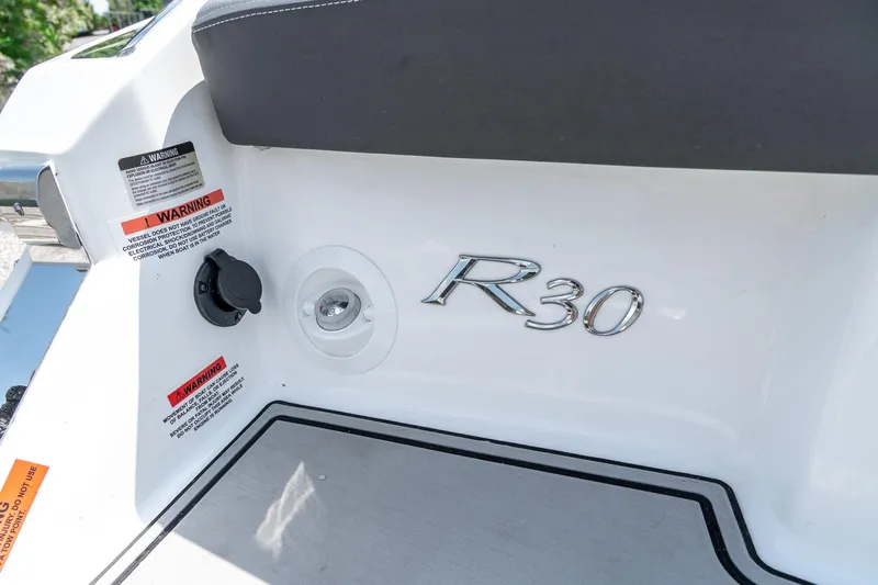  Yacht Photos Pics 2023 Cobalt R30 boat interior with warning labels and model emblem.