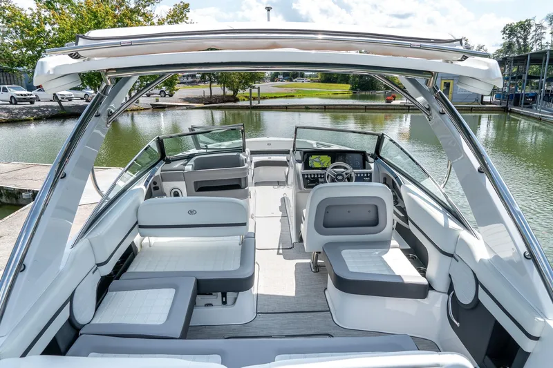  Yacht Photos Pics 2023 Cobalt R30 boat interior with modern seating and dashboard, docked by a serene lake.
