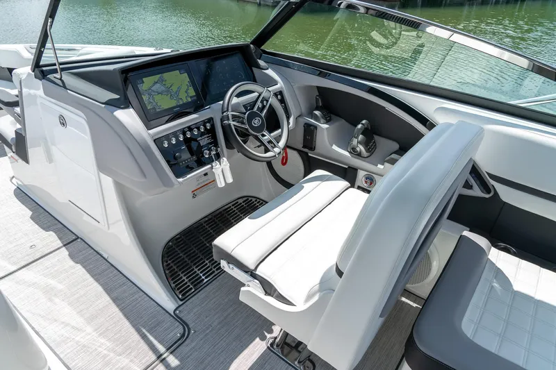  Yacht Photos Pics 2023 Cobalt R30 boat cockpit with modern steering and navigation system.