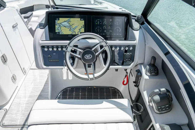  Yacht Photos Pics 2023 Cobalt R30 boat cockpit with modern steering and navigation displays.