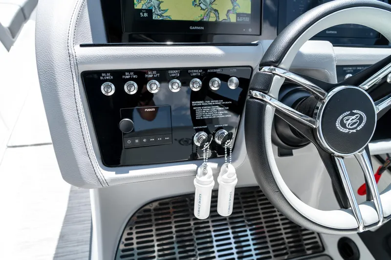  Yacht Photos Pics 2023 Cobalt R30 boat dashboard with steering wheel and control panel.