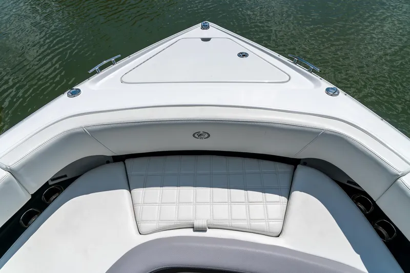  Yacht Photos Pics 2023 Cobalt R30 boat interior with white cushioned seating and sleek design on water.