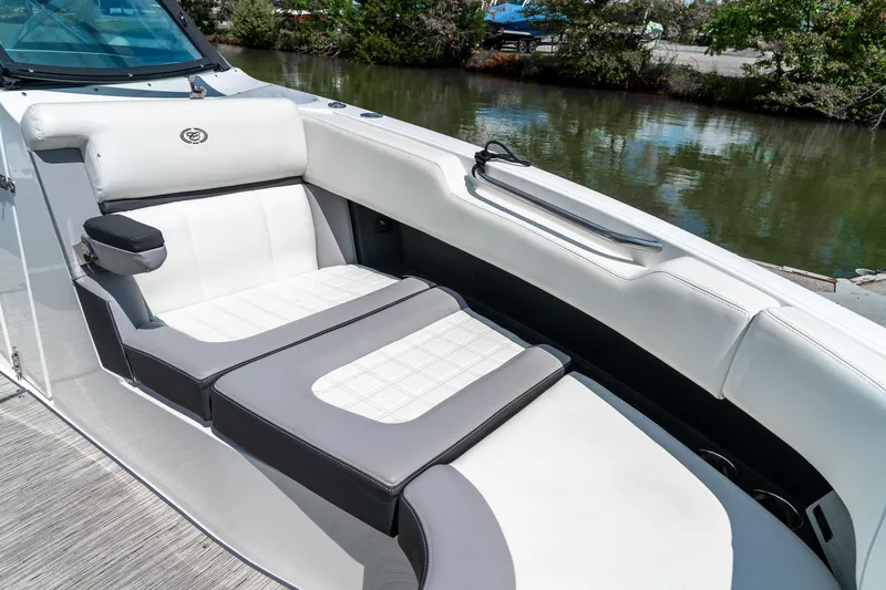  Yacht Photos Pics 2023 Cobalt R30 boat interior with luxurious white and gray seating by the water.