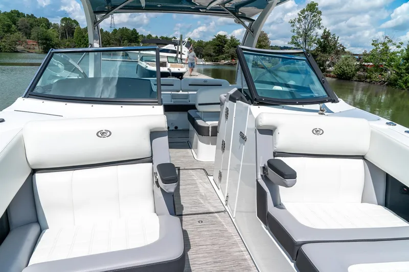  Yacht Photos Pics 2023 Cobalt R30 boat interior with luxurious seating on a serene lake.