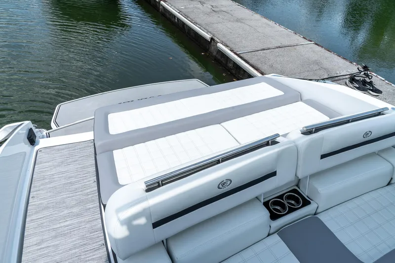  Yacht Photos Pics 2023 Cobalt R30 boat with luxurious seating and sleek design by the water.