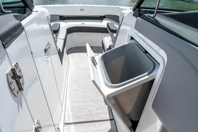  Yacht Photos Pics 2023 Cobalt R30 boat interior with open storage compartment and seating area.
