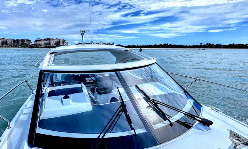 Ganesha Yacht Photos Pics Jeanneau 36 Leader 2016 cruising on a sunny day with coastal buildings in view.